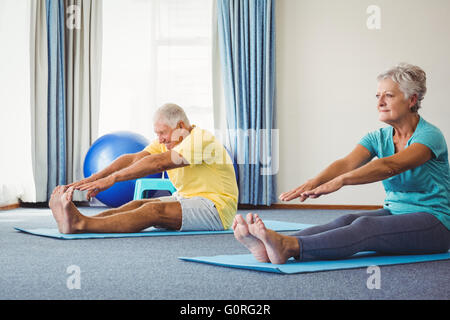 Side view of seniors doing exercises Stock Photo