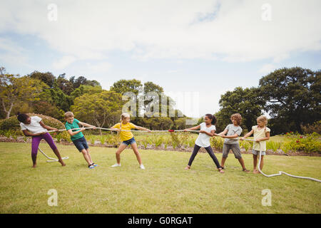 Children pulling a rope in tug of war Stock Photo