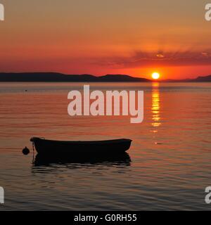 Boat on the adriatic sea at amazing sunset. Podgora, Croatia Stock Photo