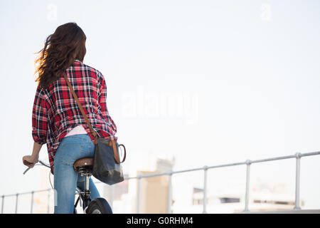 Hipster riding a bike Stock Photo