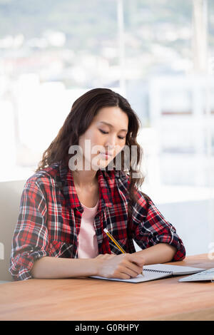 Hipster taking notes in a notebook Stock Photo