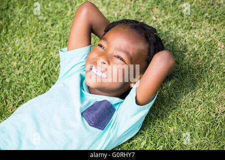 Smiling boy lying on grass Stock Photo