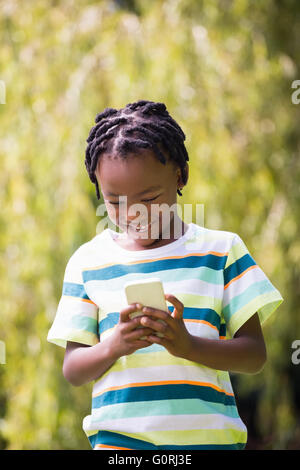 A kid playing with a mobile phone Stock Photo