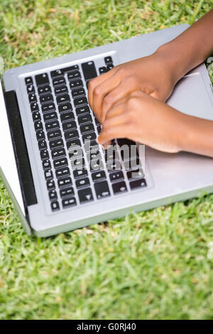 Close up of kid playing with his laptop Stock Photo