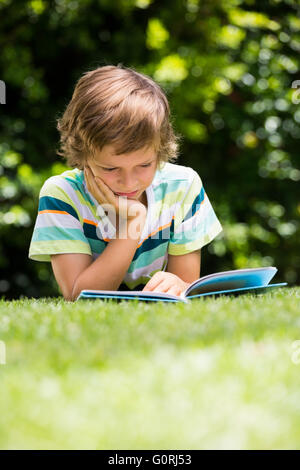 A little boy is reading a book Stock Photo