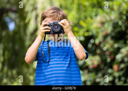 Portrait of young boy taking a photo face to the camera Stock Photo