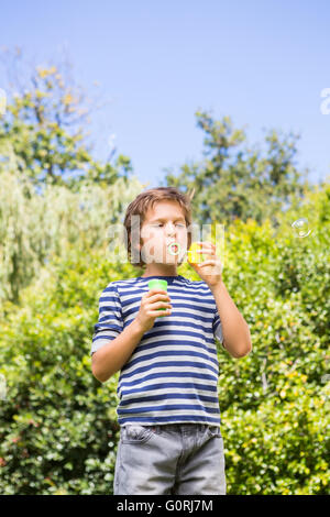 Cute boy playing with bubbles Stock Photo