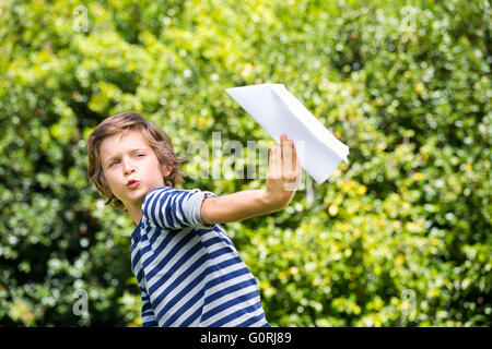 Portrait of cute boy playing with a paper plane Stock Photo