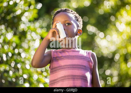 Boy using a asthma inhalator Stock Photo