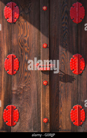 A detailed view shows the ornamental metal hardware and the beautiful grain of unpainted wooden doors at the Giyoden Hall inside Kyoto Imperial Palace, in central Kyoto, Japan. Stock Photo