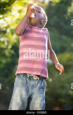 Boy using a asthma inhalator Stock Photo