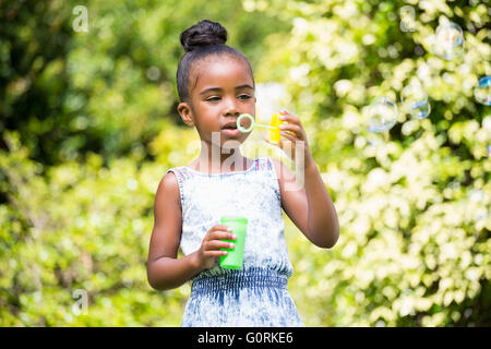 Little girl making bubble at park Stock Photo