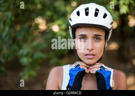 Woman fastening her cycling helmet Stock Photo