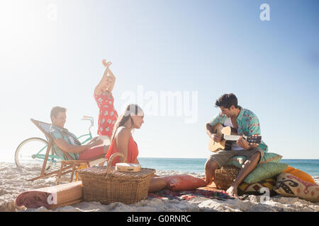 Friends playing the guitar and dancing Stock Photo