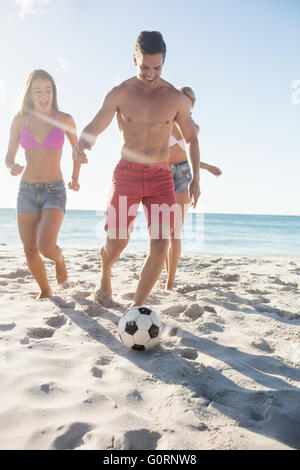 Friends playing football Stock Photo