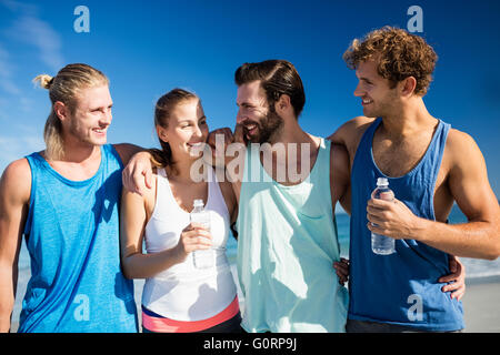 Friends hugging on the beach Stock Photo