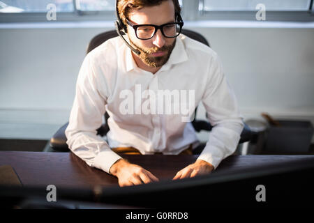 Businessman with glasses working on computer Stock Photo