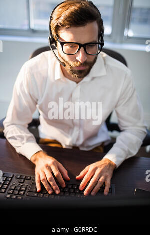 Businessman with glasses working on computer Stock Photo