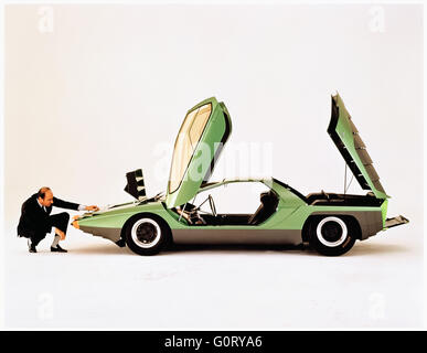 Nuccio Bertone (1914-1997) admires the 1968 Alfa Romeo Carabo concept car designed by Marcello Gandini whilst working for design Gruppo Bertone design house. This was the first vehicle to feature scissor doors. Stock Photo