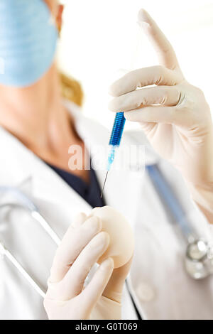 Female researcher/doctor inoculating flu virus into chicken eggs. Stock Photo