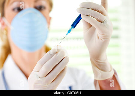 Female researcher/doctor inoculating flu virus into chicken eggs. Stock Photo