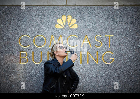 New york   The detail of entrance to 30 Rockefeller Plaza  Rockefeller centre center person taking selfie at Comcast building si Stock Photo