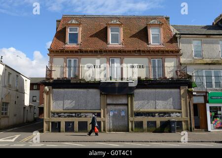 A derelict hotel boarded up on the seafront of Largs in Scotland, UK Stock Photo