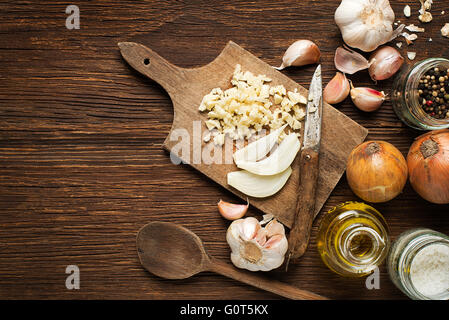 Ingredients with garlic cloves, onion and spices on wooden background. Stock Photo