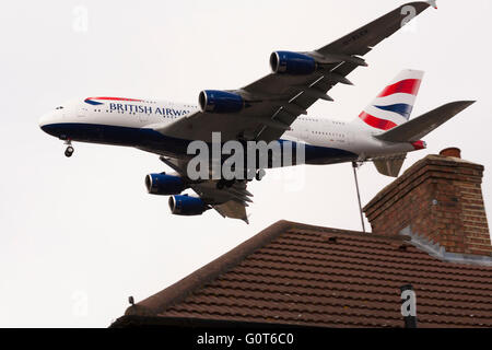 British Airways Airbus A380 - 841 (G-XLEK) landing over roof tops at London Heathrow airport.