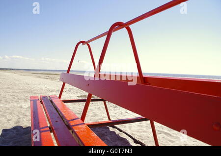 Red beach bench on a first warm spring day in Pärnu beach 2016 Stock Photo
