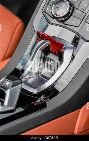 Fighter style start/stop button of a Lamborghini Aventador. Stock Photo