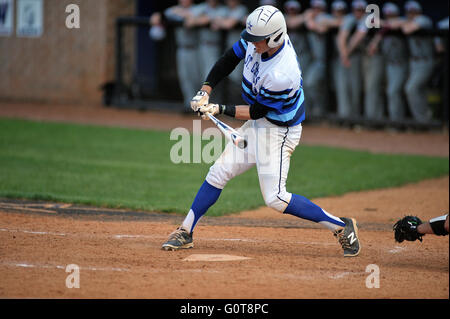 A hitter checking his swing on a pitch during a high school baseball game. USA.. Stock Photo