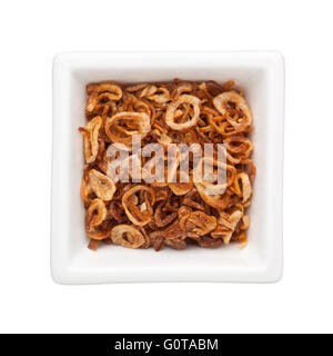Fried sliced shallots in a square bowl isolated on white background Stock Photo