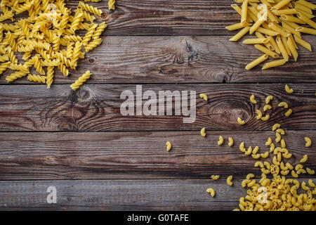 Mixed dried pasta selection on wooden background. Stock Photo