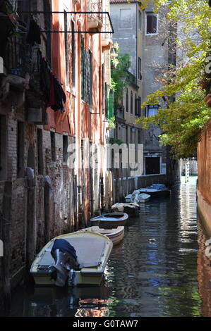 small boats on a narrow canal in Venice, Italy Stock Photo