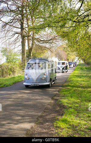 Volkswagen Split Screen camper vans in convoy on a english country road. Leicestershire, England Stock Photo