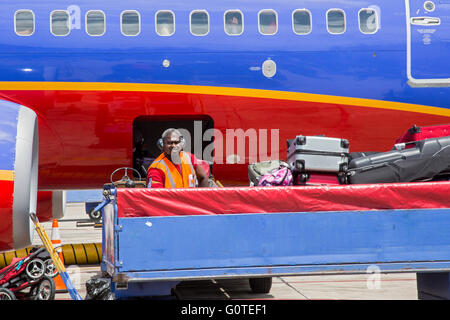 Fort Lauderdale, Florida - A Southwest Airlines baggage handler loads a plane at Fort Lauderdale-Hollywood International Airport Stock Photo