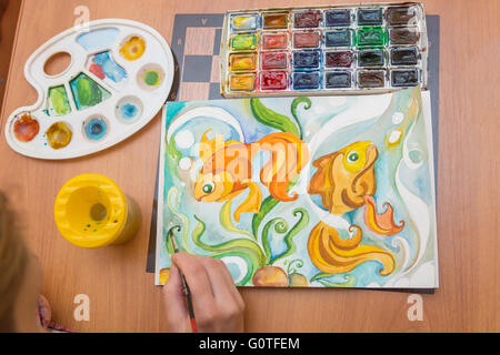 Top view of the process of drawing on watercolor paper goldfish Stock Photo