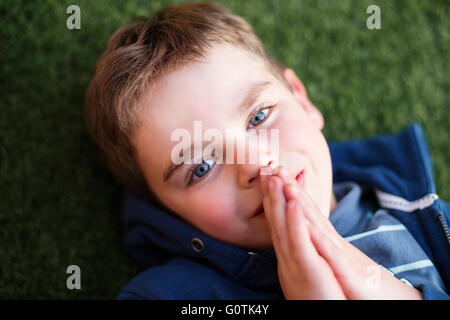 Overhead view of a boy praying