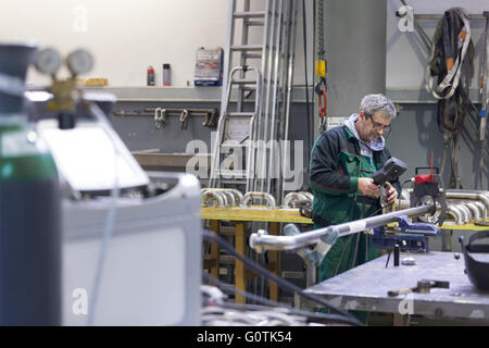 Industrial worker setting orbital welding machine. Stock Photo