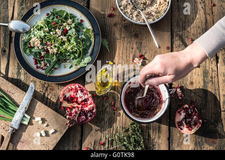 Green salad with pomegranate, manna croup and onion Stock Photo