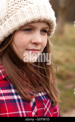 Portrait of a pretty young girl with freckles looking into the distance Stock Photo