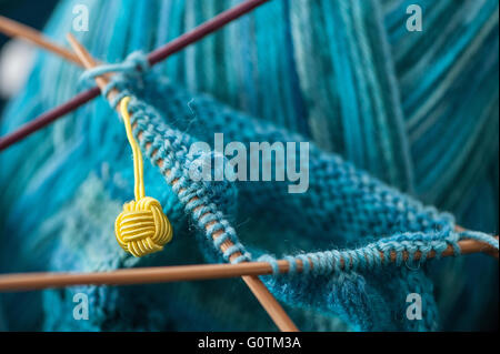 Close up of socks being knitted in the round on wooden double-pointed needles Stock Photo