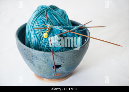 Knitting bowl with socks being made Stock Photo
