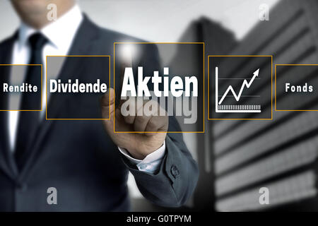 Aktien, Rendite, Dividende, Fonds (in german shares, dividend, return, fund) broker with touchscreen. Stock Photo