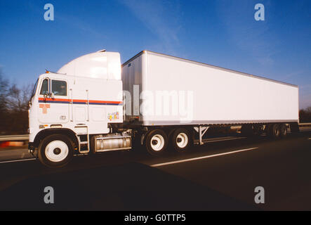 Cab over tractor trailer truck on highway Stock Photo