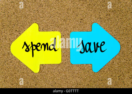 Conceptual message on yellow and blue paper notes as opposite arrows pinned on cork board with thumbtacks Stock Photo