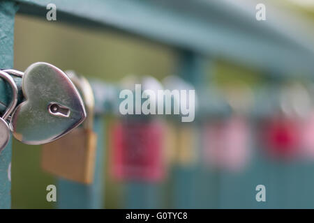 heart shaped padlock on bridge - love symbol Stock Photo