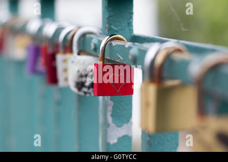 many padlocks on bridge - love symbol Stock Photo