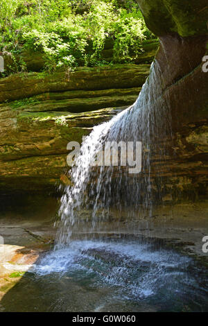 The waterfall at the sandstone cliffs of La Salle Canyon in Starved Rock State Park on the banks of the Illinois River. Stock Photo